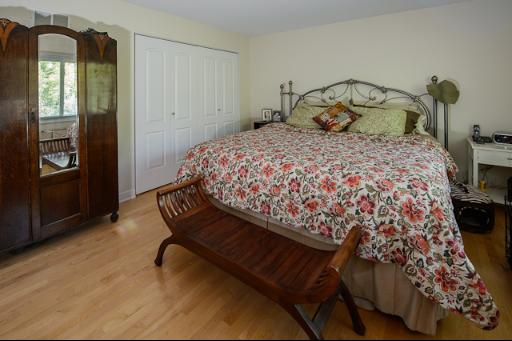 230 North Ela Road Barrington, IL 60010 - Photo 7 of 16 a bedroom with a bed and wooden floor