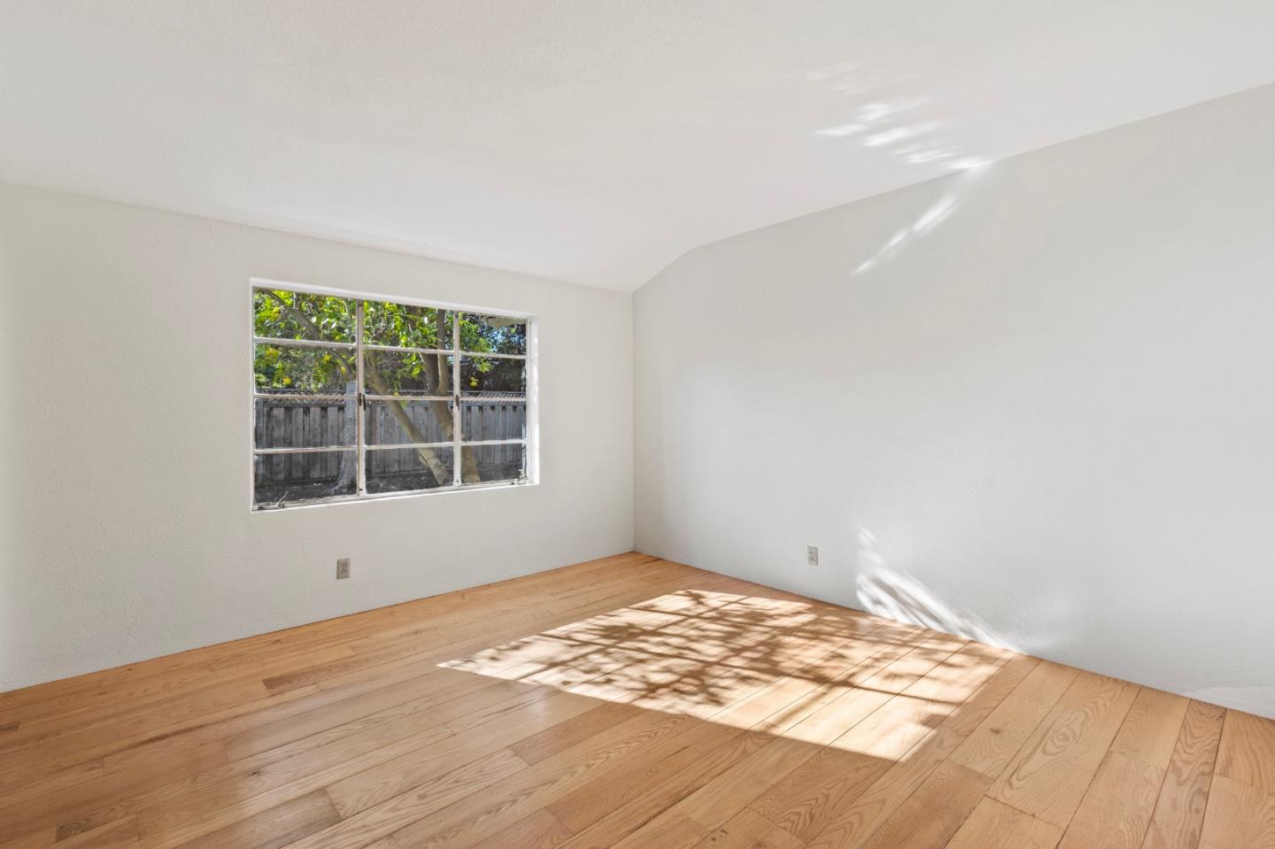 179 Eunice Avenue Mountain View, CA 94040 - Photo 14 of 23 an empty room with wooden floor and windows