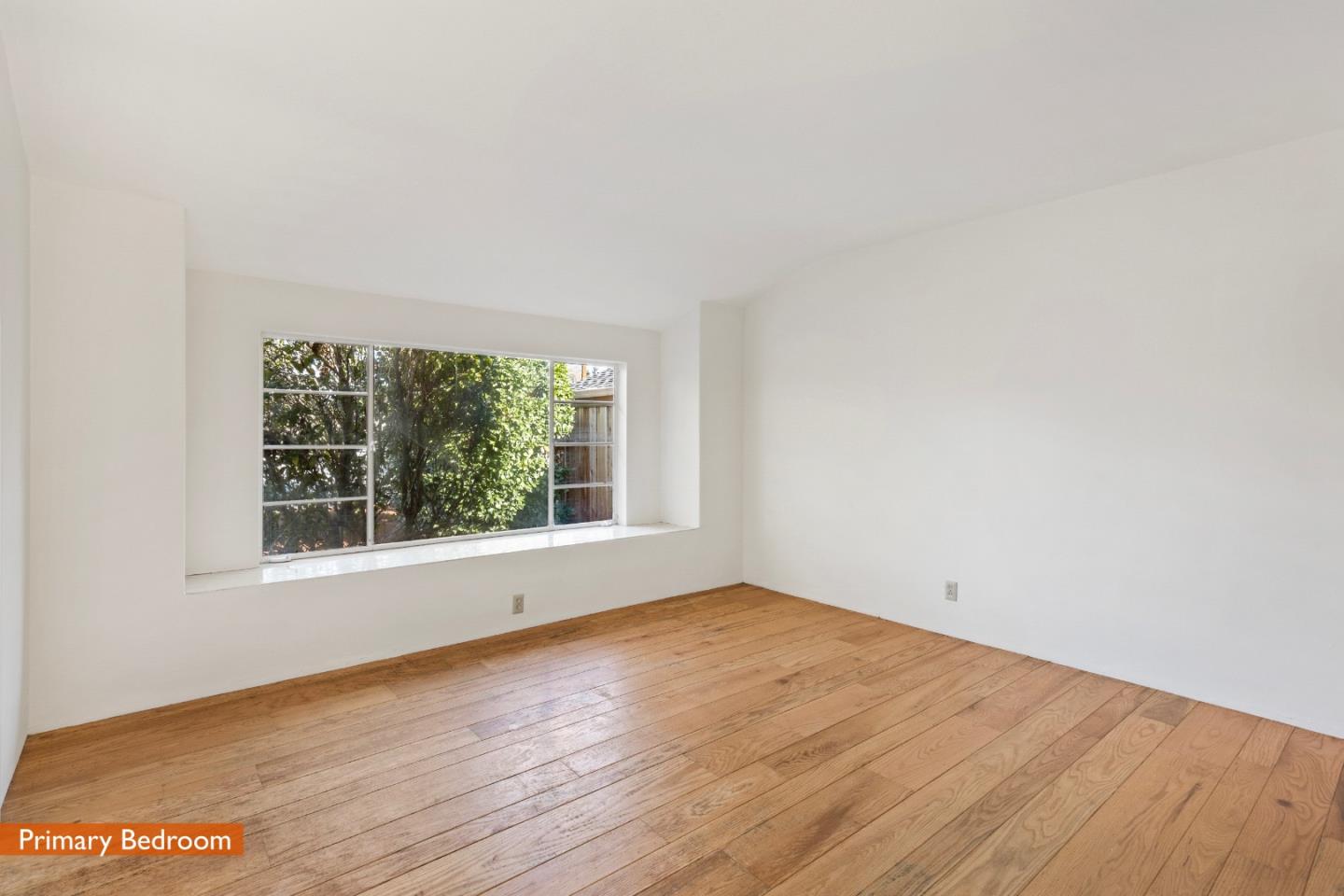 179 Eunice Avenue Mountain View, CA 94040 - Photo 8 of 23 an empty room with wooden floor and windows