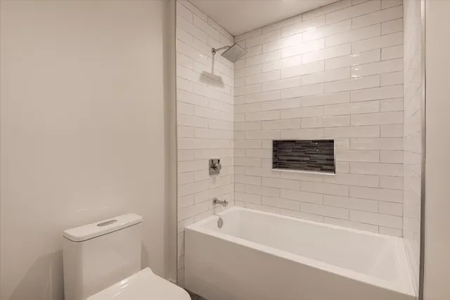 a bathroom with a bathtub and a toilet