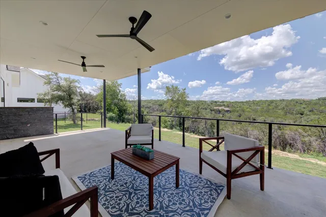 a roof deck with table and chairs