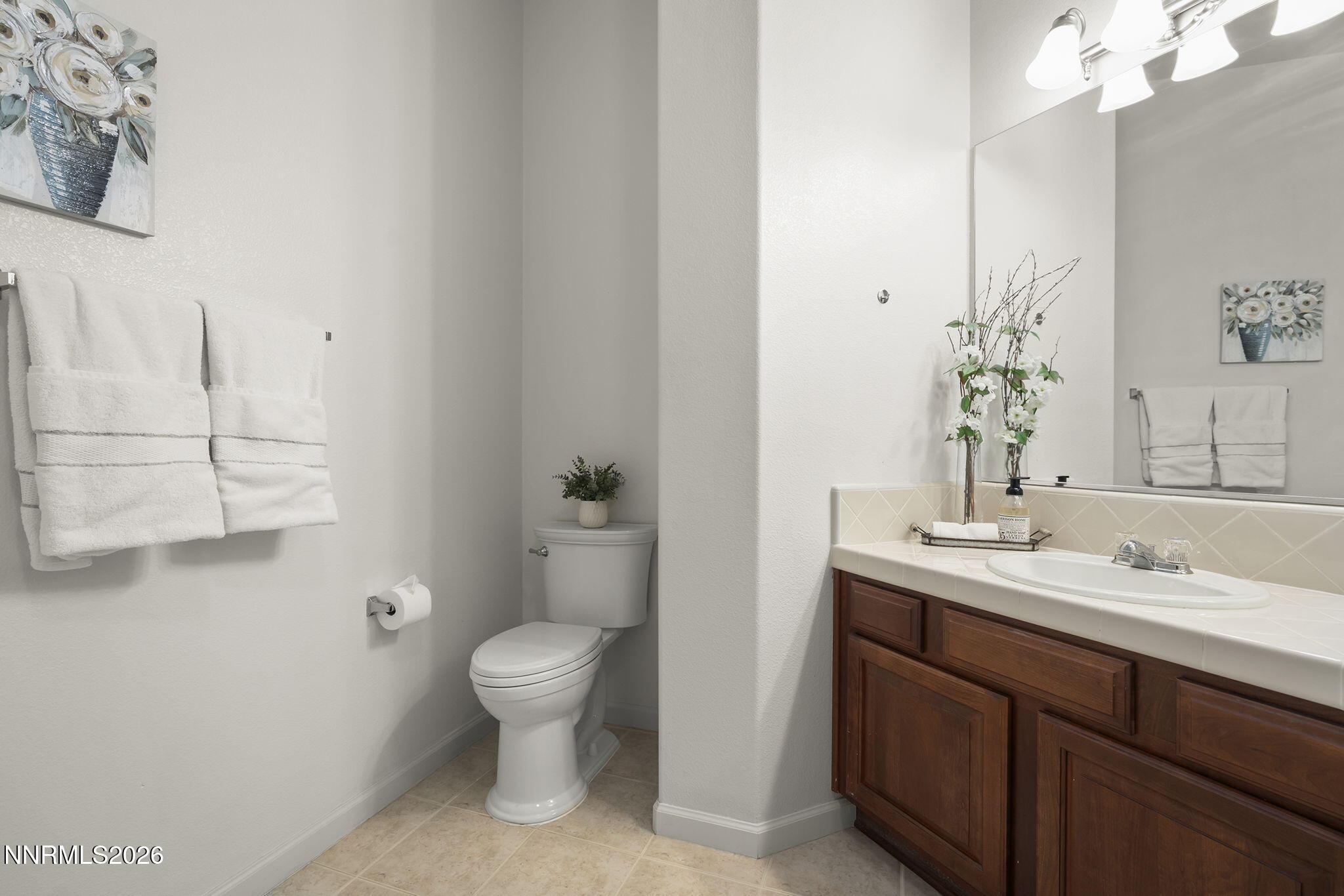 9900 Wilbur May Parkway, Unit 304 Reno, NV 89521 - Photo 25 of 47 a bathroom with a granite countertop sink a toilet and a mirror