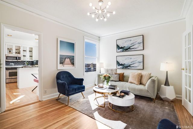 a living room with furniture and a chandelier