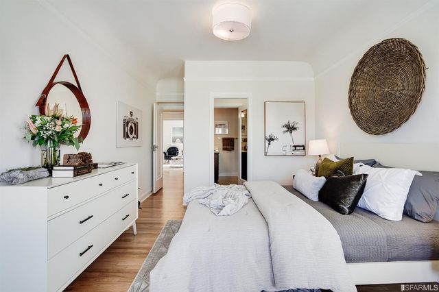 a bedroom with a large bed and a chandelier