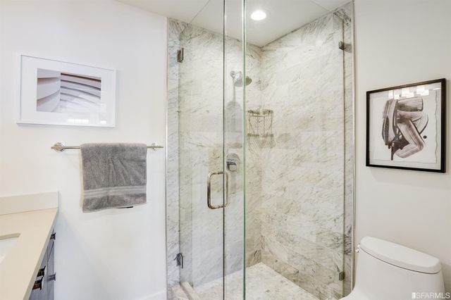 a bedroom with a bed table flowerpot and window