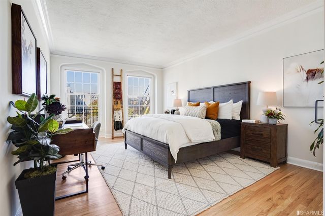 a bedroom with a bed and potted plant