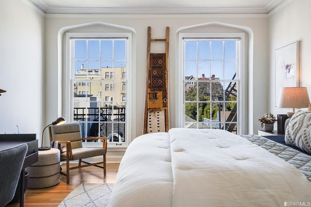 a bedroom with a bed and a potted plant