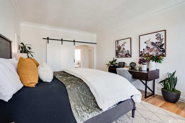 a bedroom with bed and a couch