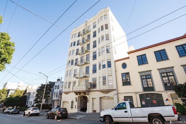a view of a hallway with wooden walls and stairs