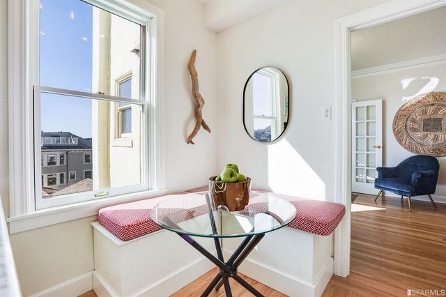 a dining room with furniture and wooden floor