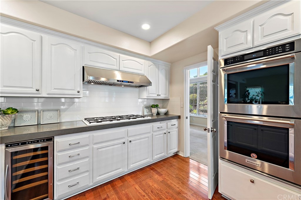 2 Tidemark Laguna Niguel, CA 92677 - Photo 11 of 57 a kitchen with stainless steel appliances white cabinets and stove