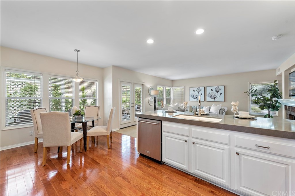 2 Tidemark Laguna Niguel, CA 92677 - Photo 12 of 57 a kitchen with a dining table chairs wooden floor and appliances