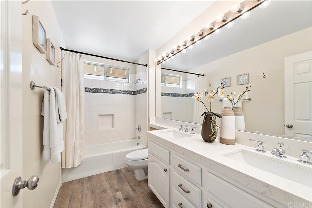 2 Tidemark Laguna Niguel, CA 92677 - Photo 36 of 57 a bathroom with a double vanity sink toilet mirror and shower
