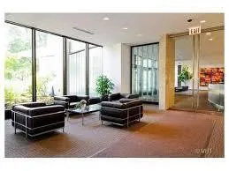 a living room with furniture and floor to ceiling windows