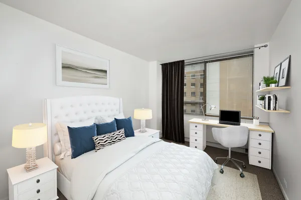 a bedroom with a bed and a view of kitchen