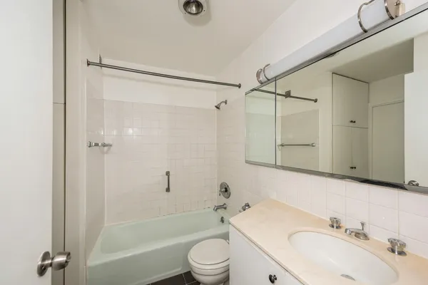 a bathroom with a sink toilet tub and shower