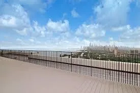 a view of a balcony with wooden fence