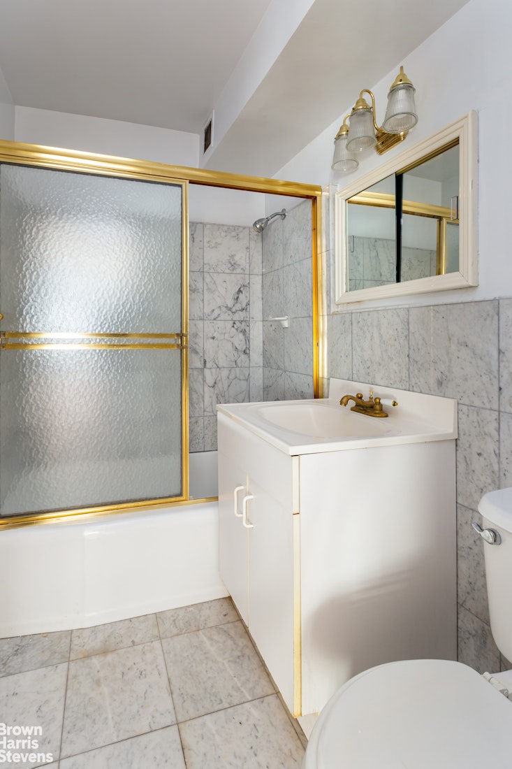 315 East 70th Street, Unit 8G Manhattan, NY 10021 - Photo 12 of 16 a bathroom with a sink a toilet and a bathtub
