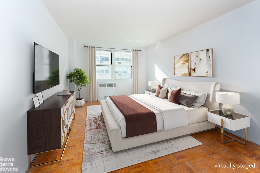 315 East 70th Street, Unit 8G Manhattan, NY 10021 - Photo 6 of 16 a spacious bedroom with a bed and a flat screen tv