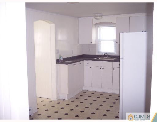636 Myrtle Road North Brunswick, NJ 08902 - Photo 1 of 8 a bathroom with a sink a mirror and a shower