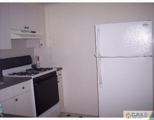 636 Myrtle Road North Brunswick, NJ 08902 - Photo 3 of 8 a kitchen with a stove and a refrigerator