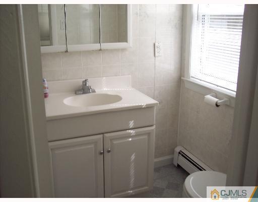 636 Myrtle Road North Brunswick, NJ 08902 - Photo 7 of 8 a bathroom with a sink toilet and vanity