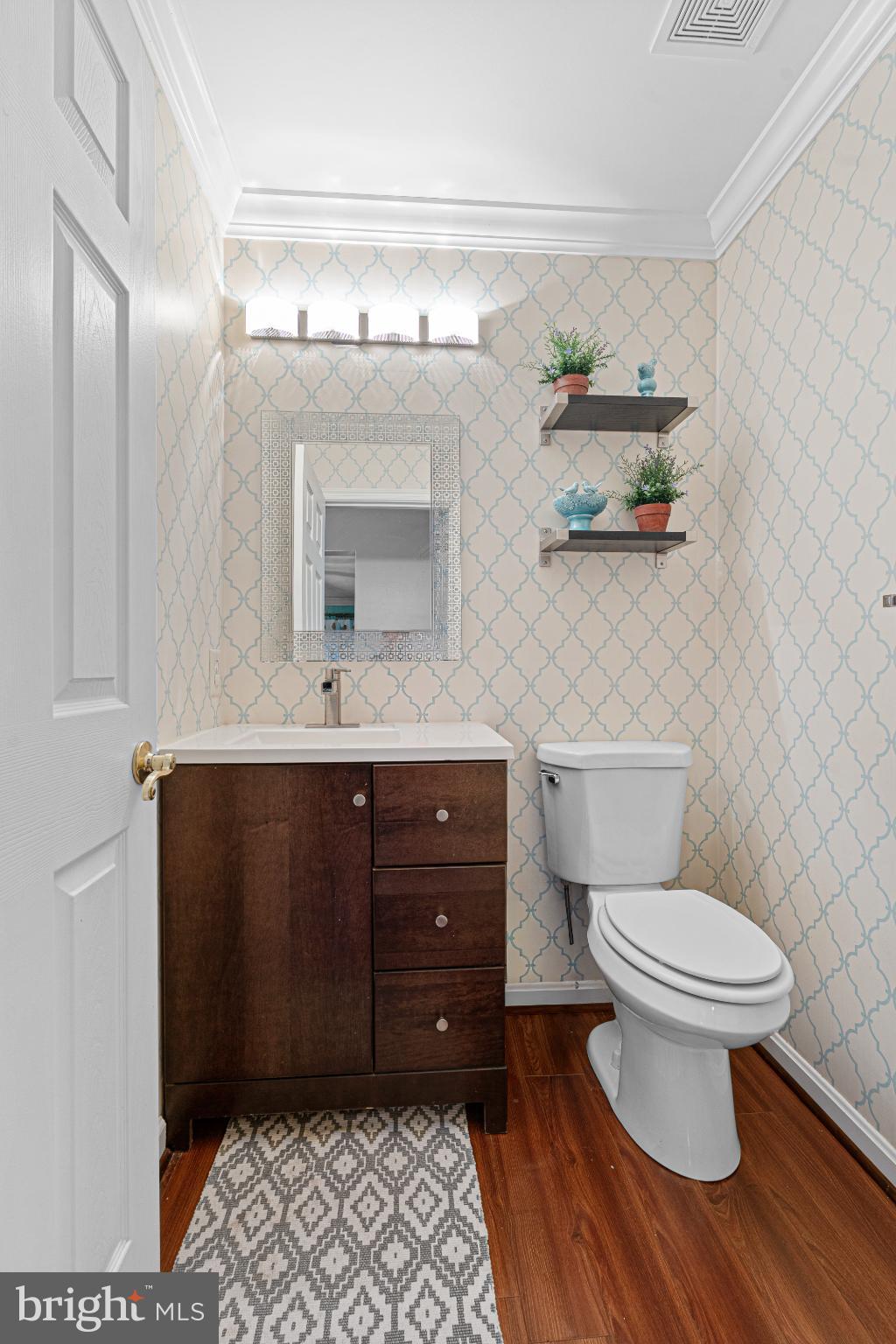 4635 Greencove Circle Sparrows Point, MD 21219 - Photo 15 of 48 a bathroom with a toilet a sink and mirror