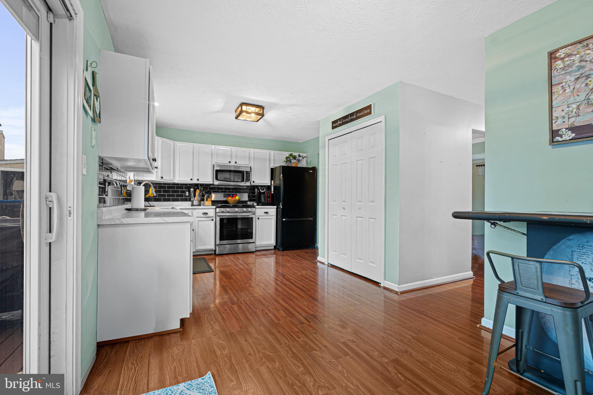 4635 Greencove Circle Sparrows Point, MD 21219 - Photo 18 of 48 a kitchen with wooden floors and refrigerator