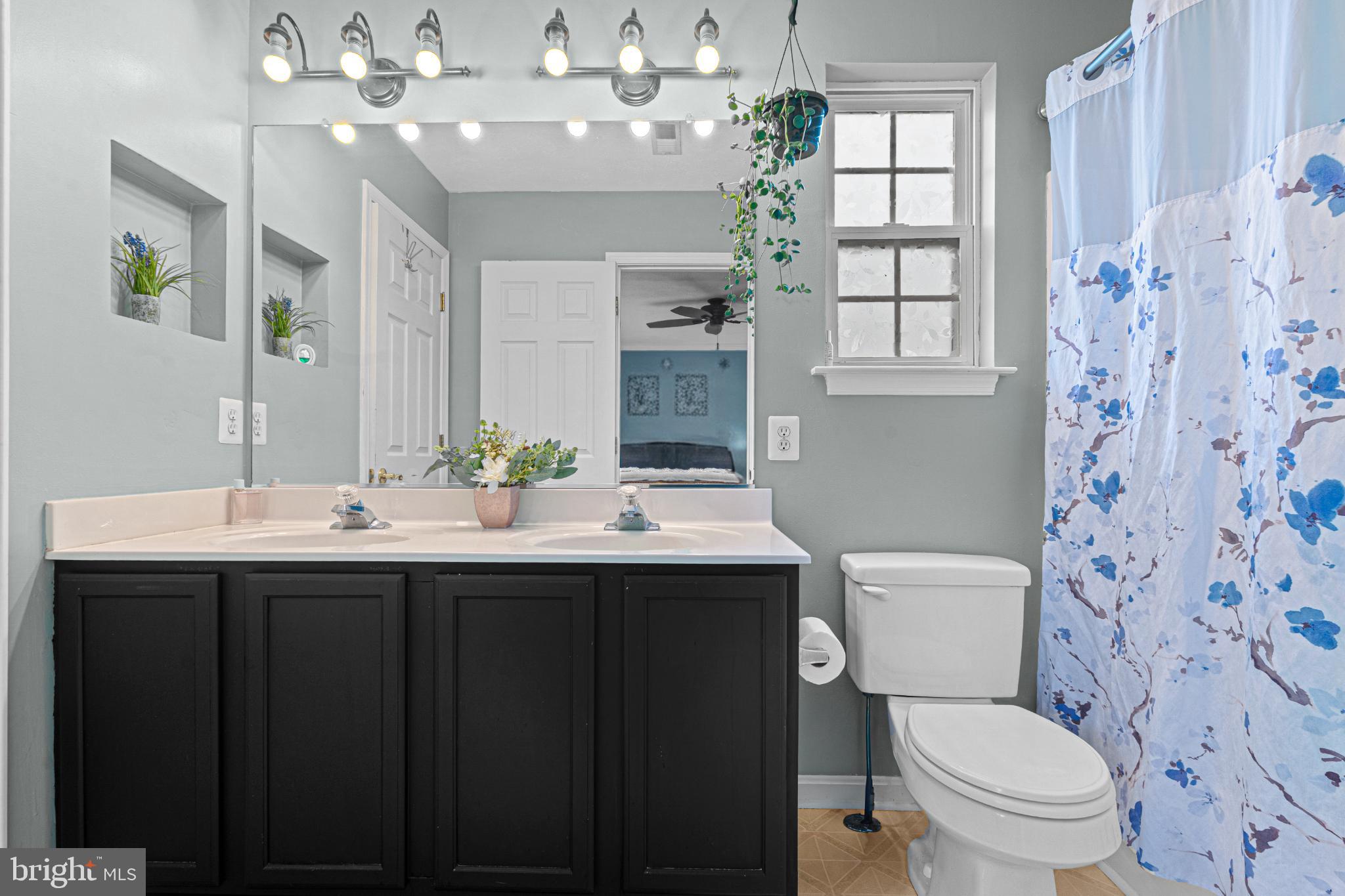 4635 Greencove Circle Sparrows Point, MD 21219 - Photo 25 of 48 a bathroom with a sink vanity mirror and toilet