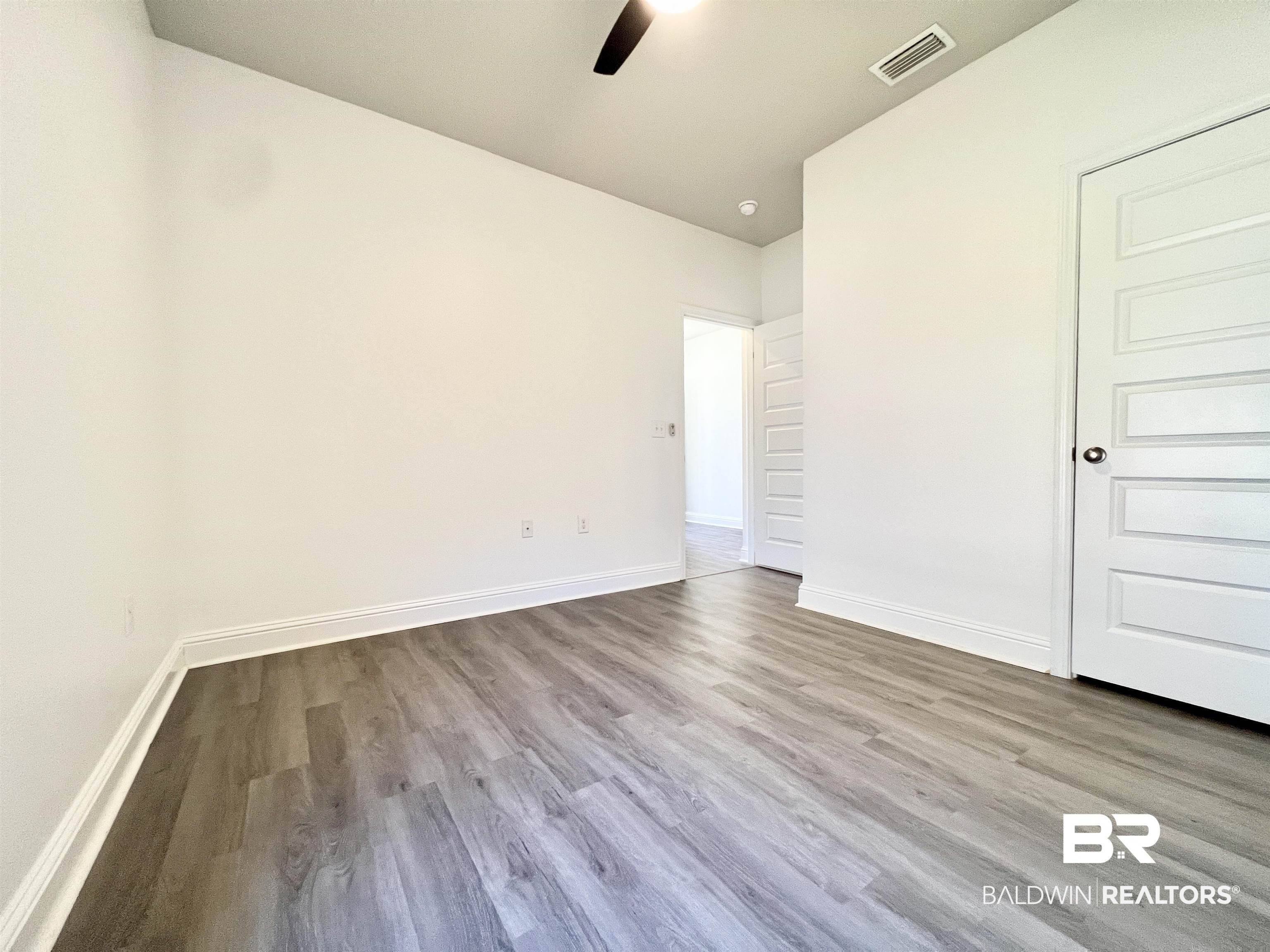 24785 Slater Mill Road Daphne, AL 36526 - Photo 19 of 46 Spare room with light hardwood / wood-style flooring and ceiling fan