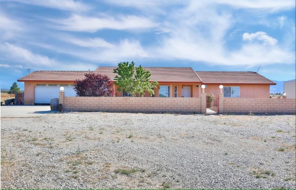 10280 Middleton Road Phelan, CA 92371 - Photo 1 of 1 a front view of a house with a yard and garage