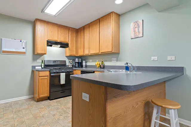 a kitchen with a sink cabinets and appliances