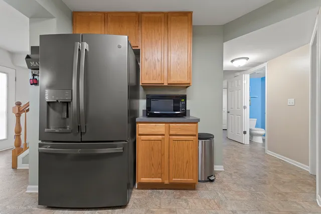 a kitchen with stainless steel appliances granite countertop a refrigerator and a stove
