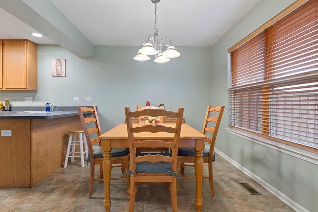 a view of a dining room with furniture and chandelier