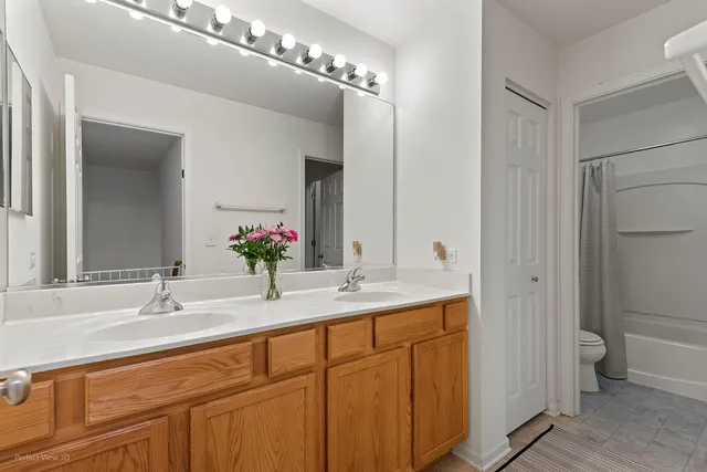 a bathroom with a double vanity sink and a mirror