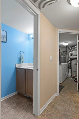 a view of a hallway with a kitchen