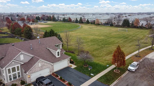an aerial view of residential houses with outdoor space and ocean view