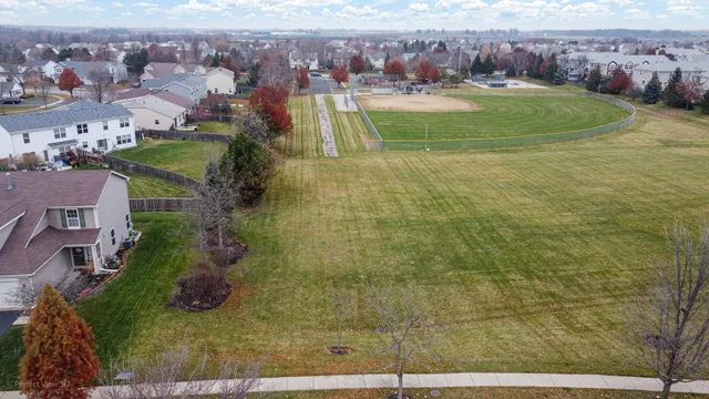 an aerial view of residential houses with outdoor space and swimming pool