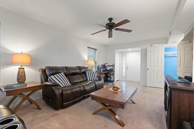 a living room with furniture and a lamp
