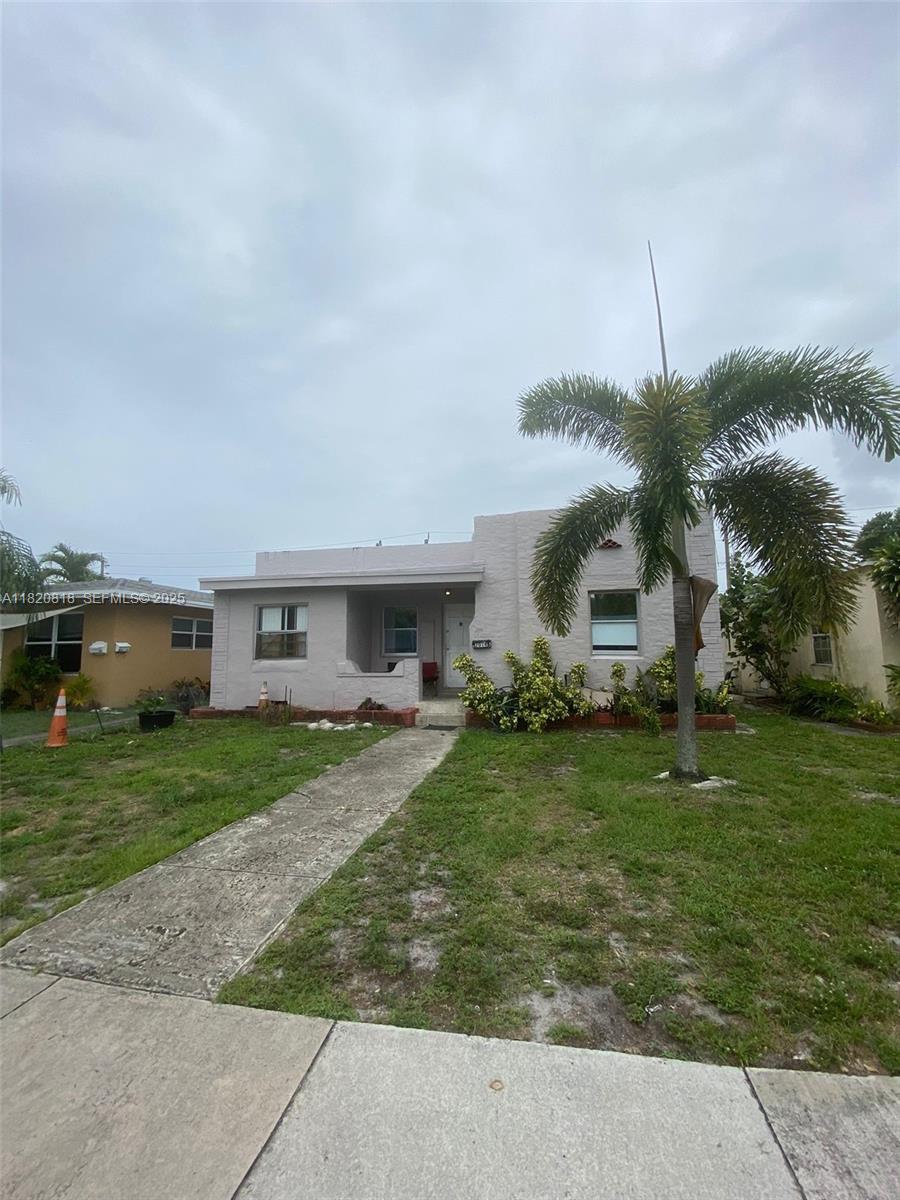 2014 Funston Street Hollywood, FL 33020 - Photo 2 of 5 a front view of house with yard and car parked