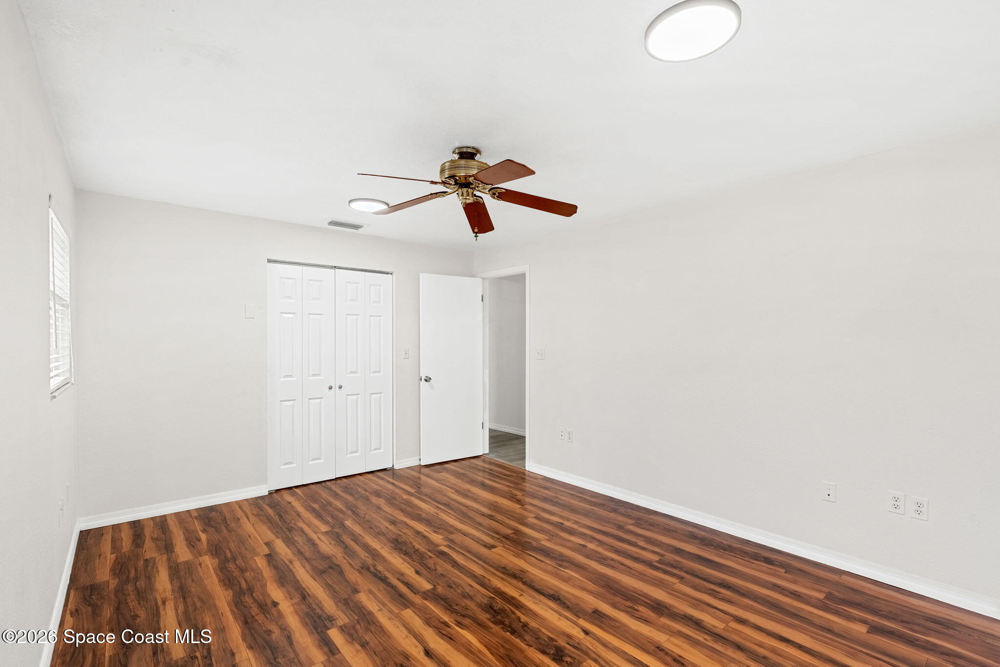 5 Lee Street Cocoa, FL 32926 - Photo 14 of 29 a view of room with wooden floor and ceiling fan