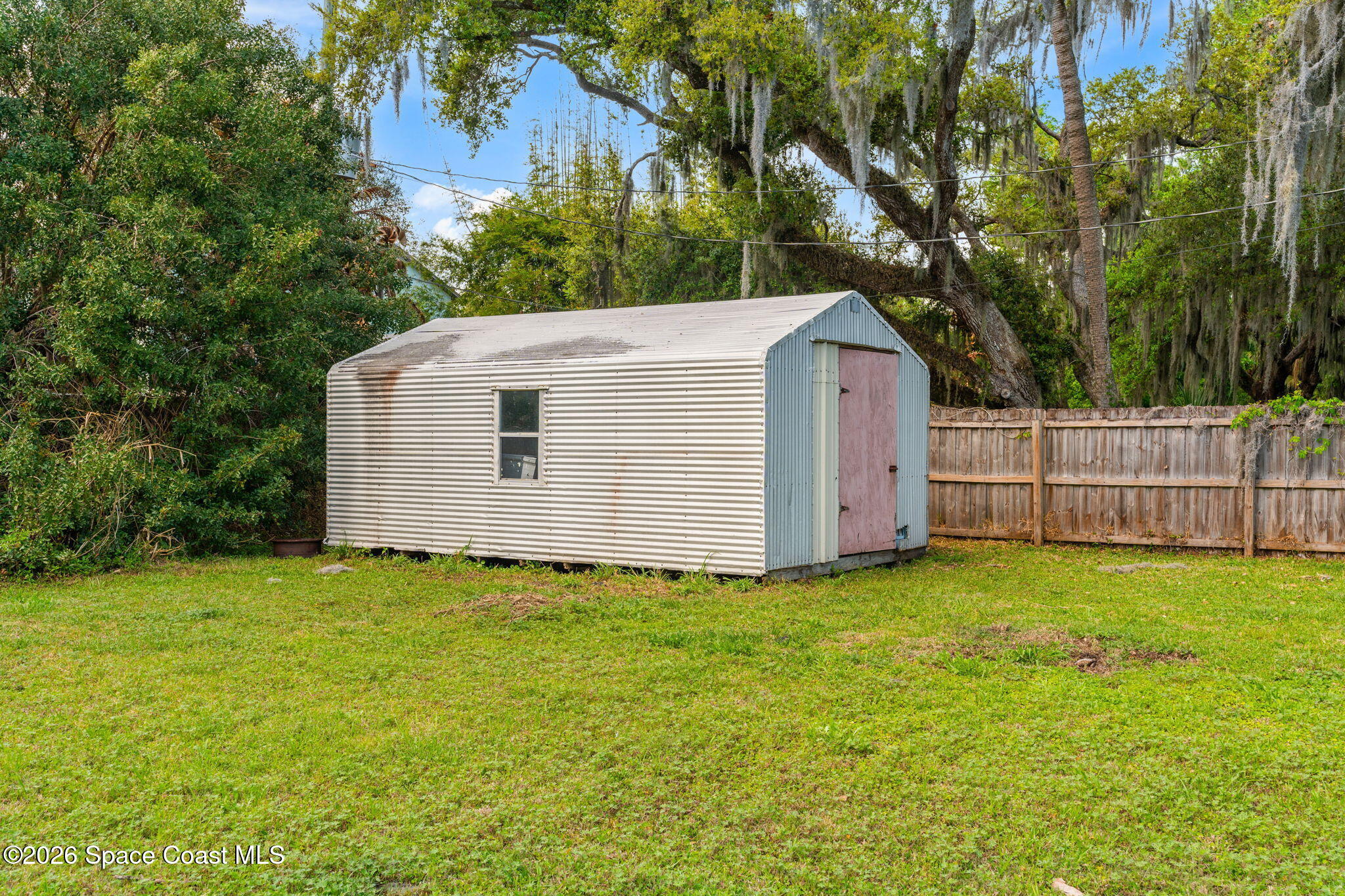 5 Lee Street Cocoa, FL 32926 - Photo 26 of 29 a backyard of a house with plants and large tree