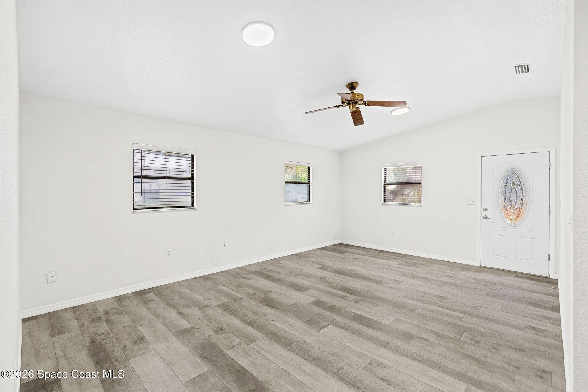 5 Lee Street Cocoa, FL 32926 - Photo 5 of 29 wooden floor in an empty room with a window