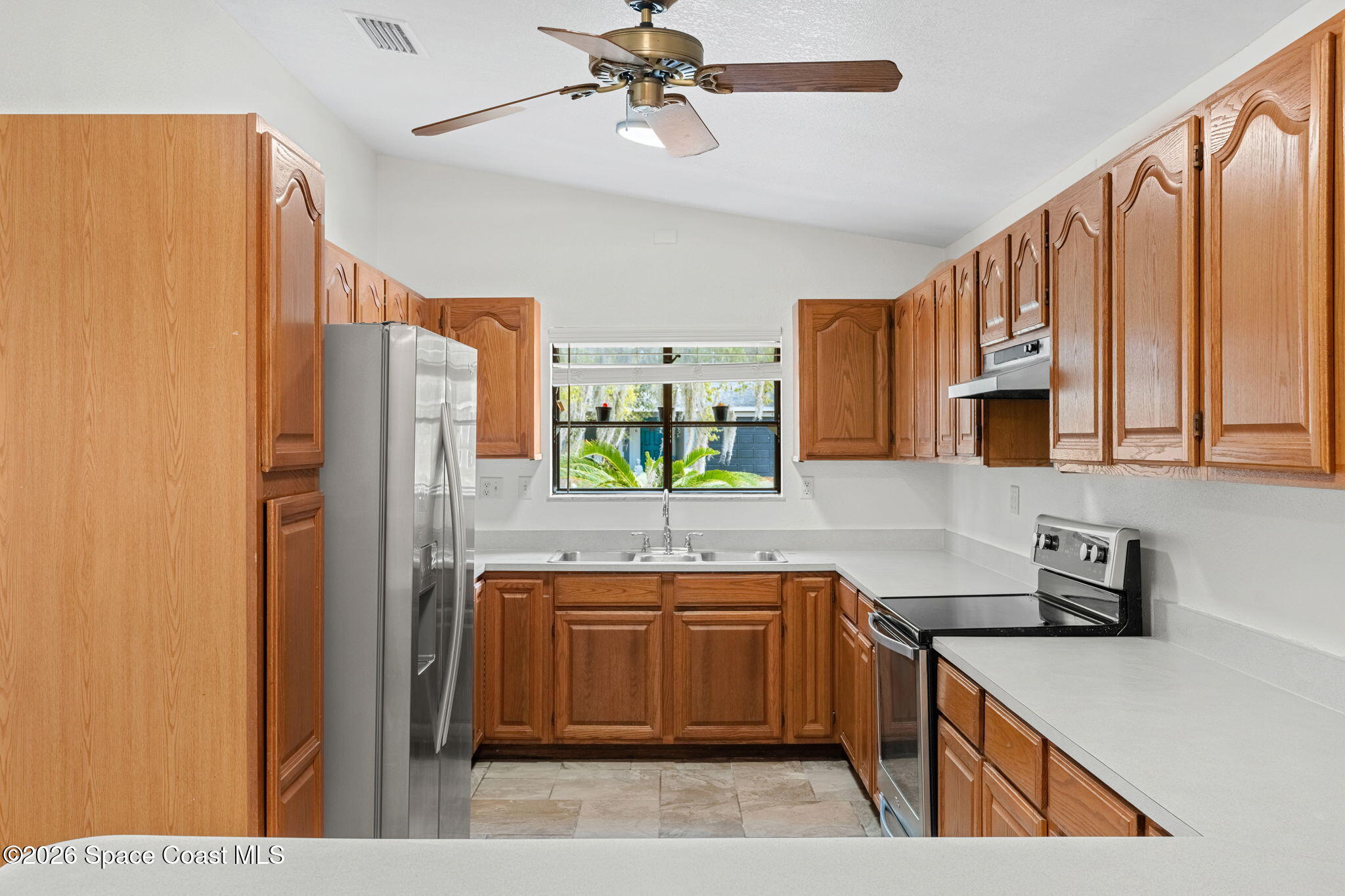 5 Lee Street Cocoa, FL 32926 - Photo 7 of 29 a kitchen with stainless steel appliances granite countertop a sink refrigerator and cabinets