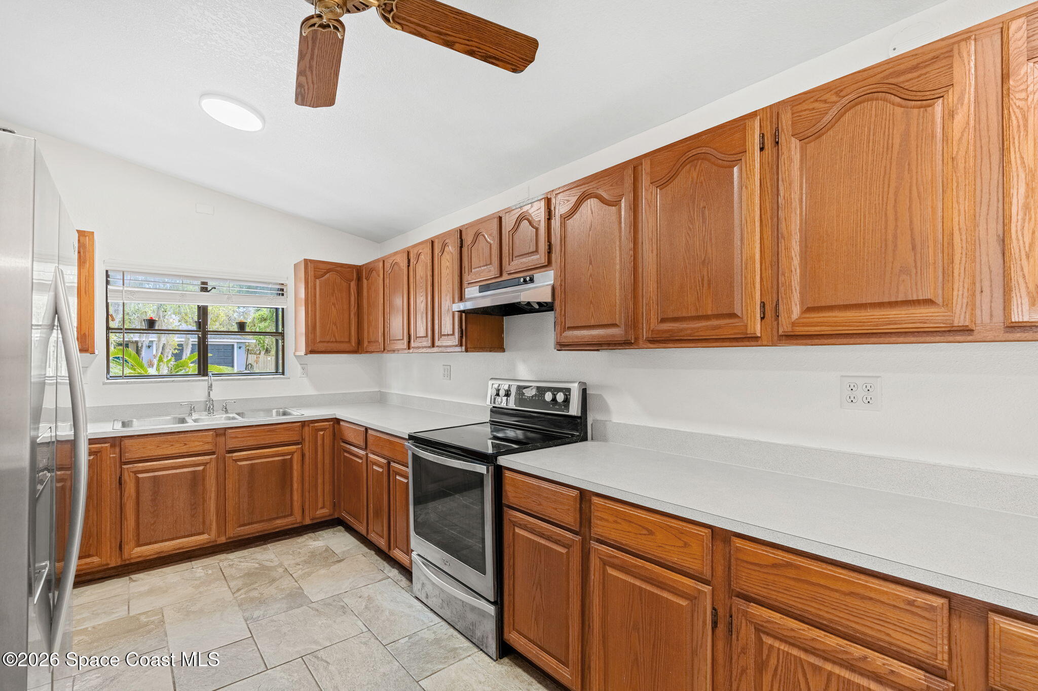 5 Lee Street Cocoa, FL 32926 - Photo 8 of 29 a kitchen with stainless steel appliances granite countertop a sink and cabinets
