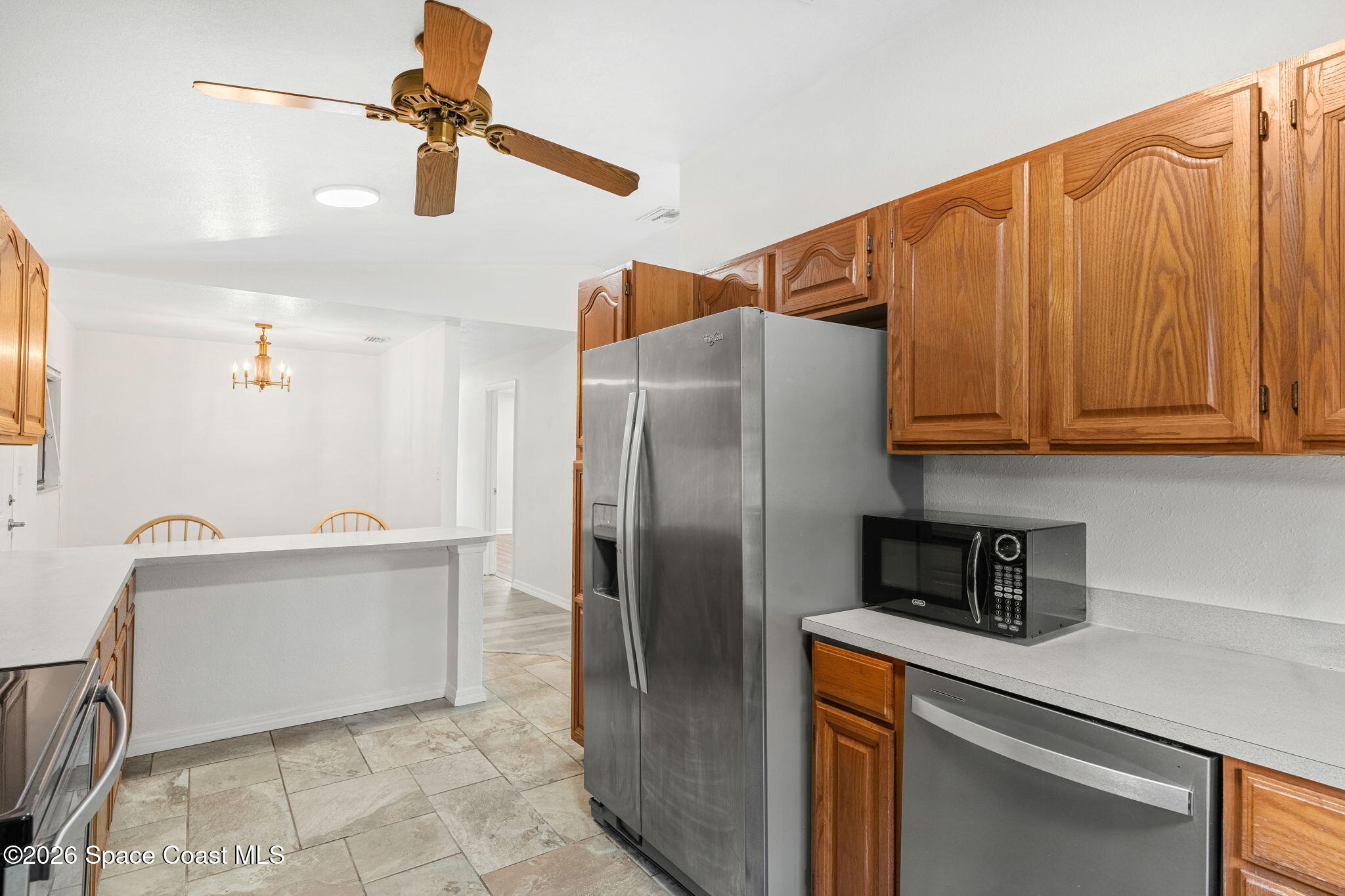 5 Lee Street Cocoa, FL 32926 - Photo 9 of 29 a kitchen with stainless steel appliances a refrigerator and a sink