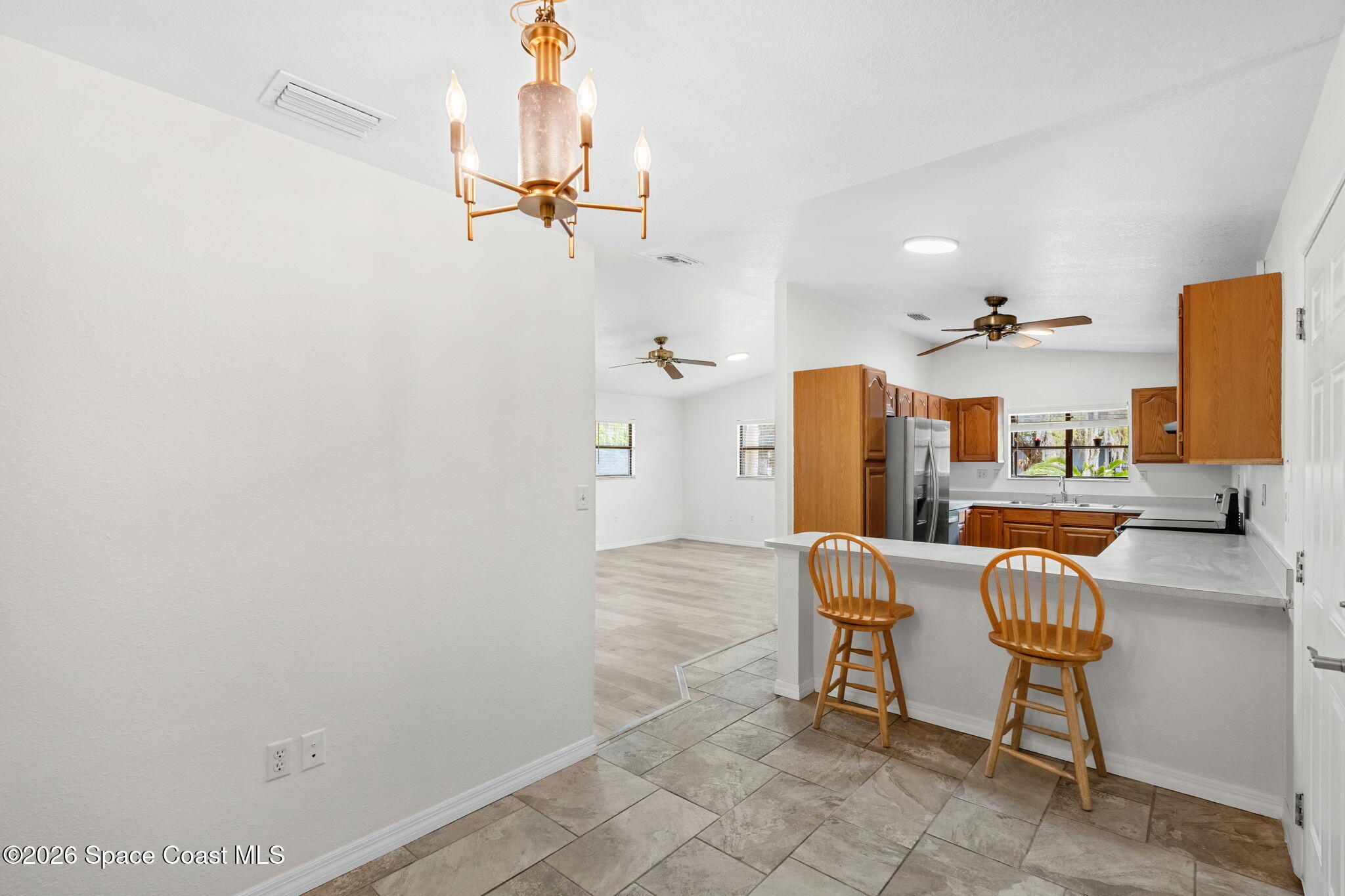 5 Lee Street Cocoa, FL 32926 - Photo 10 of 29 a living room with furniture and a chandelier