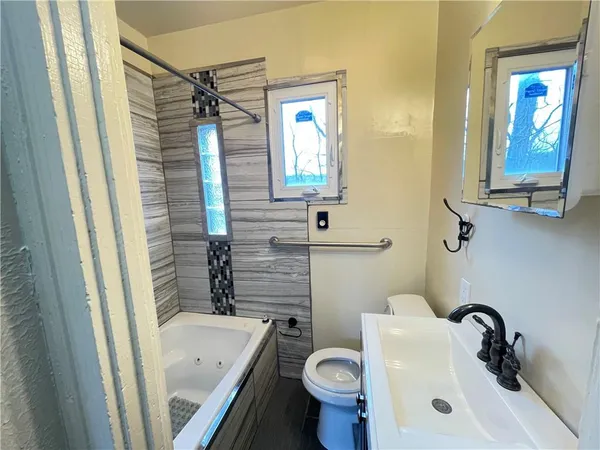 a bathroom with a sink toilet and shower