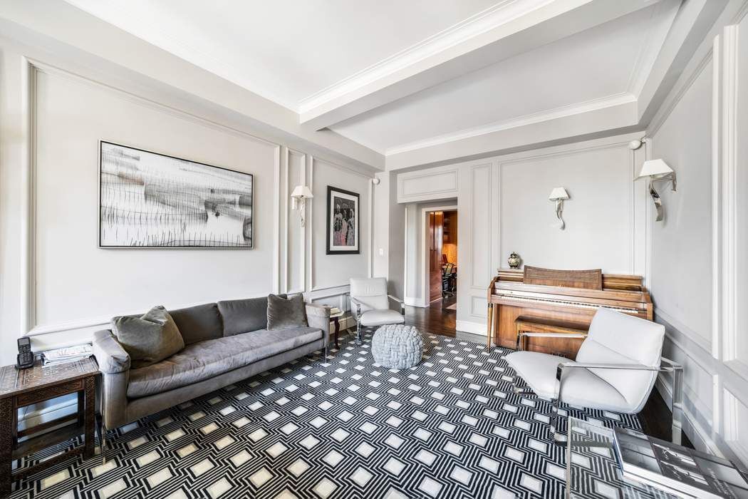 139 East 94th Street, Unit 11CD Manhattan, NY 10128 - Photo 10 of 28 a living room with furniture and a wooden floor