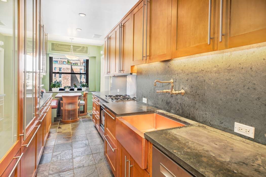 139 East 94th Street, Unit 11CD Manhattan, NY 10128 - Photo 14 of 28 a kitchen with a sink and large window